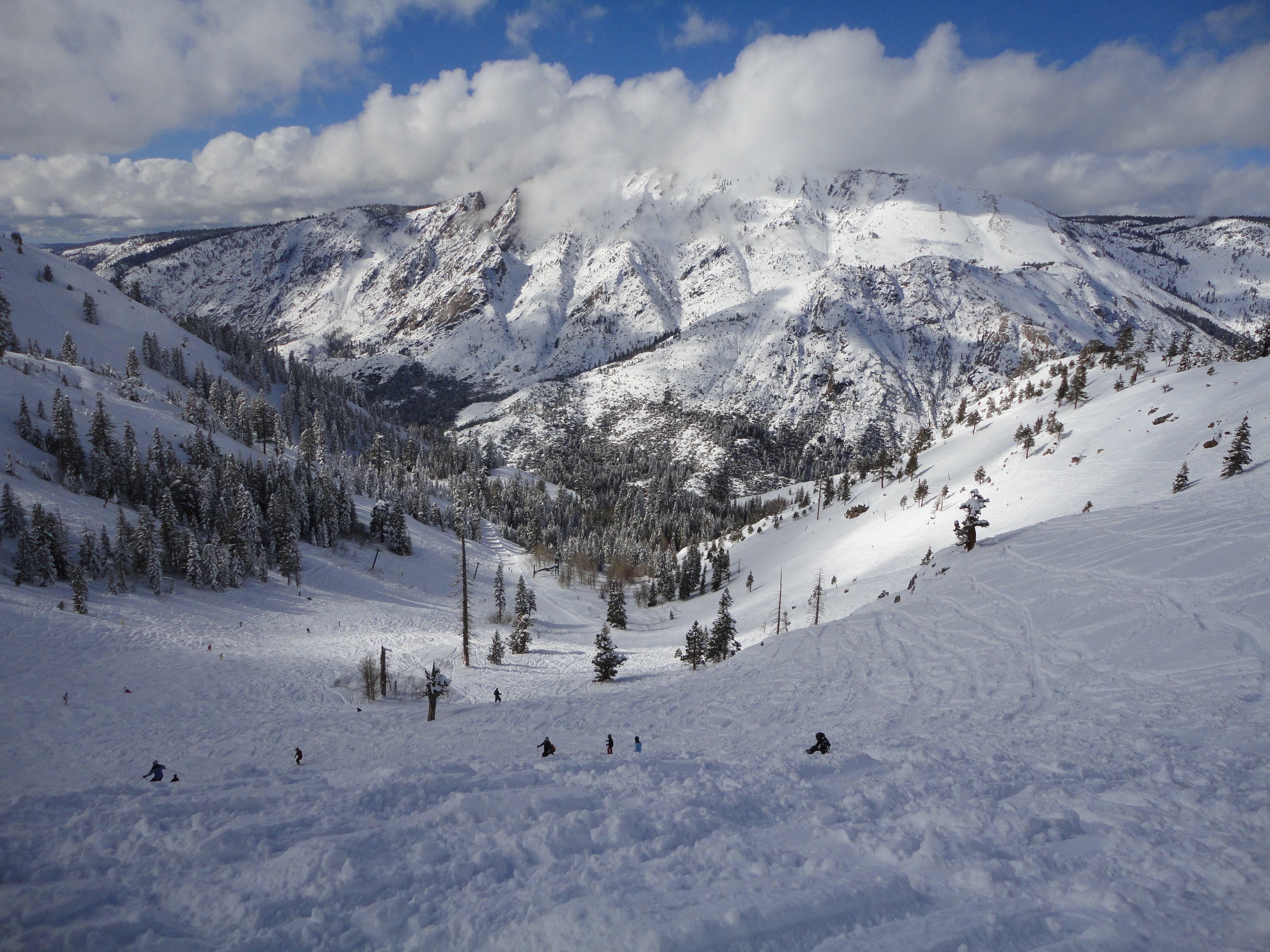 Bear Valley in USA - a group of people skiing down a snow covered mountain.