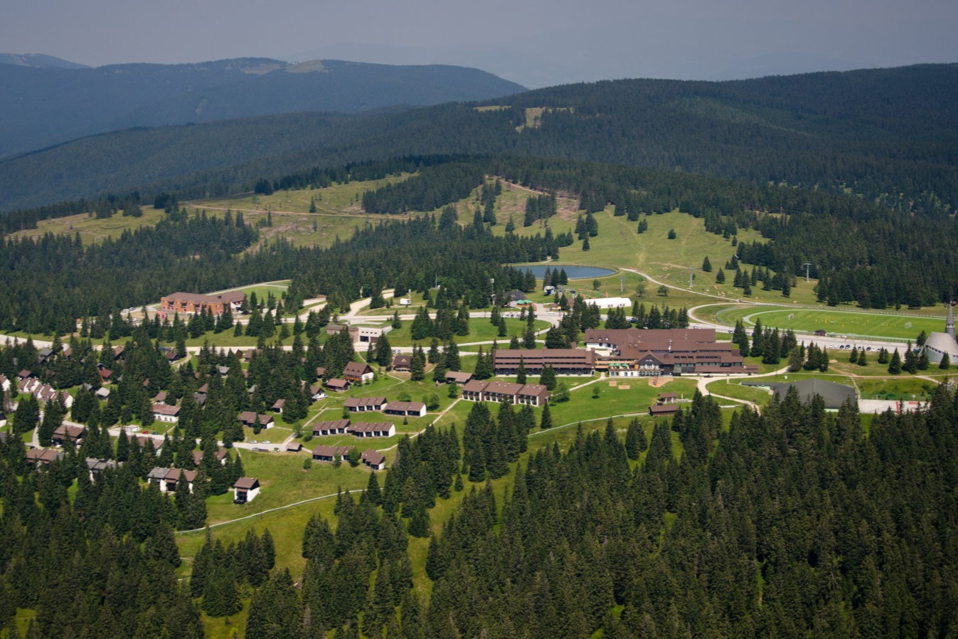 Schwäbeleholzlift – Sonthofen in Germany: a view of a resort surrounded by pine trees.
