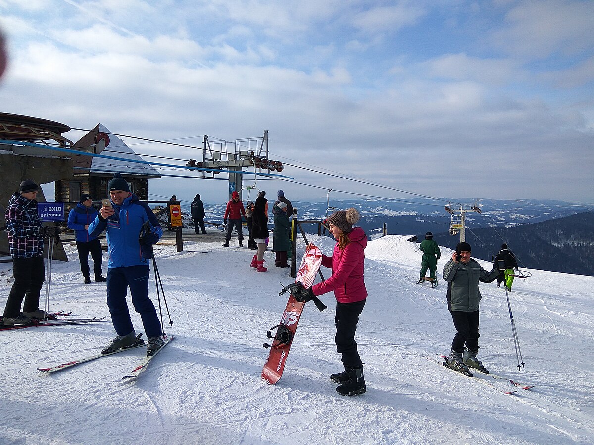 Sjezdovka in Czech Republic - a group of people standing on top of a ski slope.