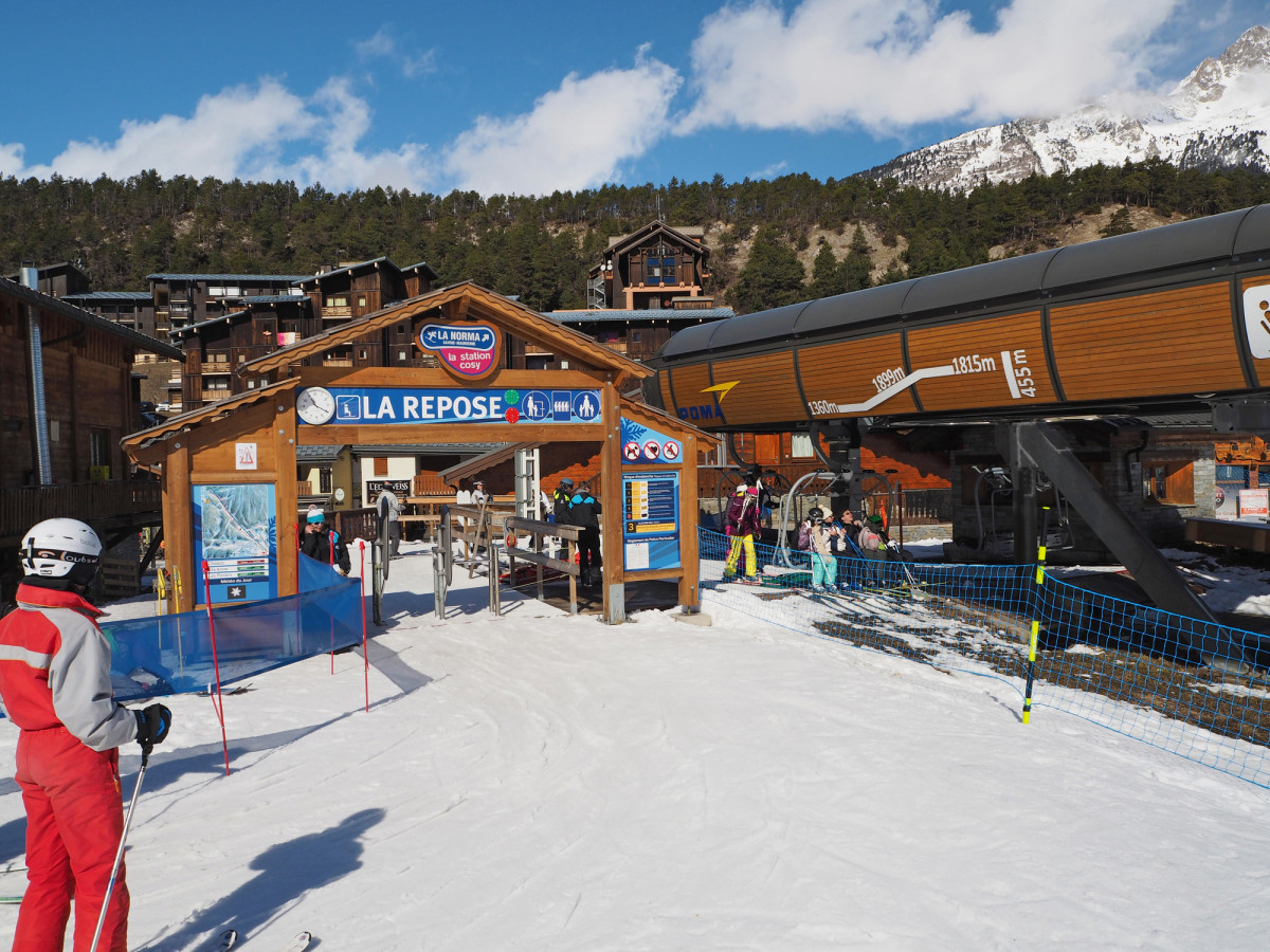 La Norma in France - a person in a red ski suit skiing down a slope.