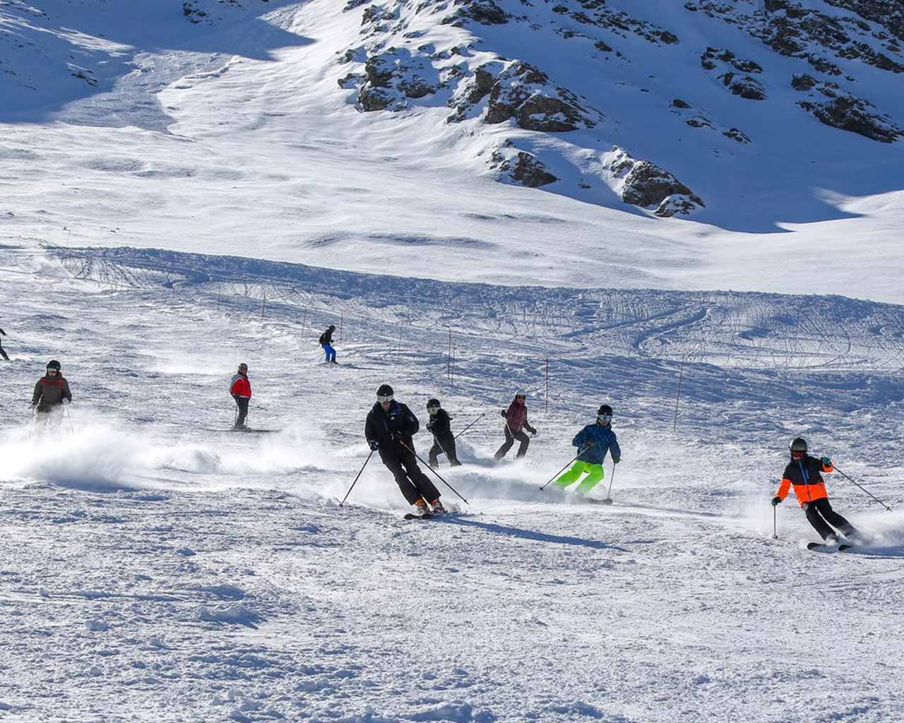 La Norma in France - a group of people skiing down a snowy slope.