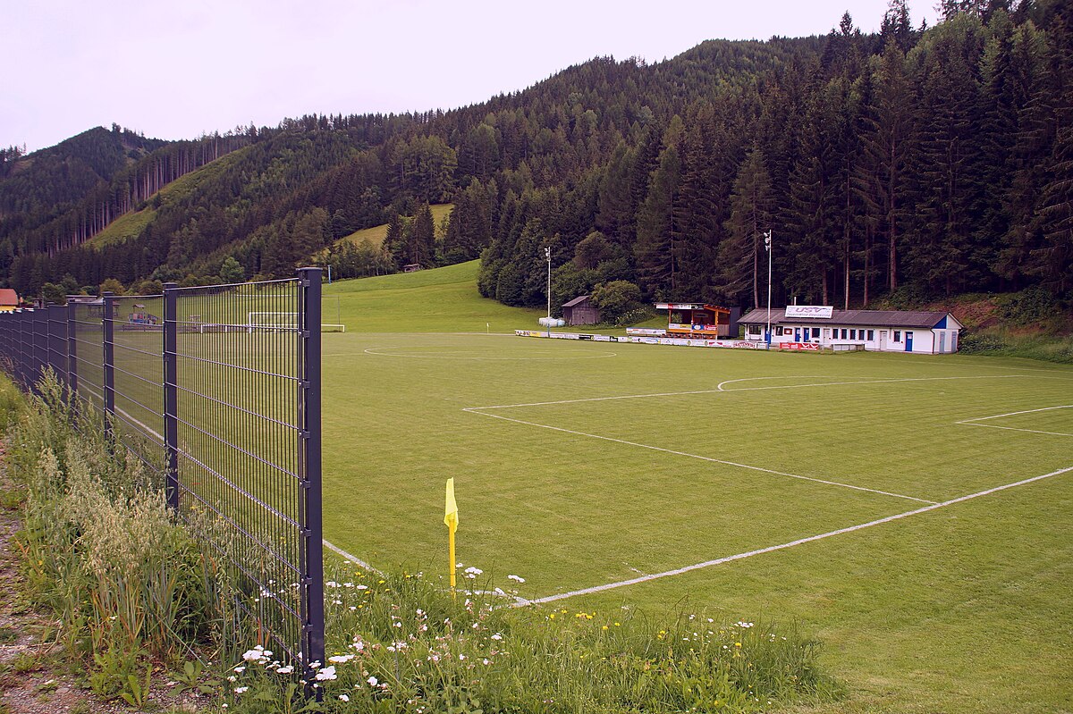 Pölstal in Austria - a soccer field with a fence in the middle.
