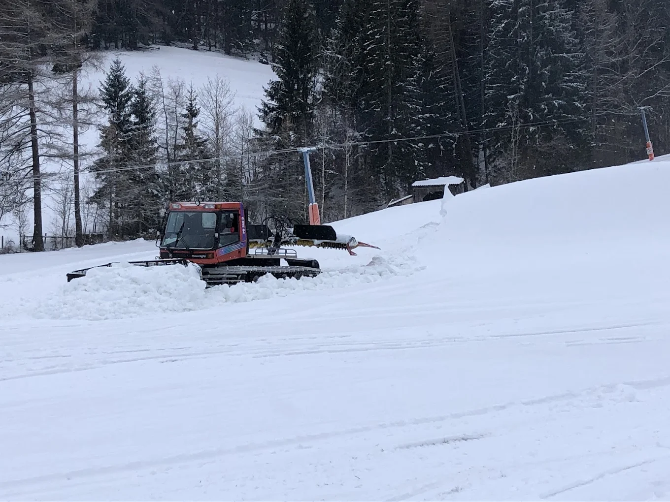 Pölstal in Austria - a tractor is parked in the snow on a hill.