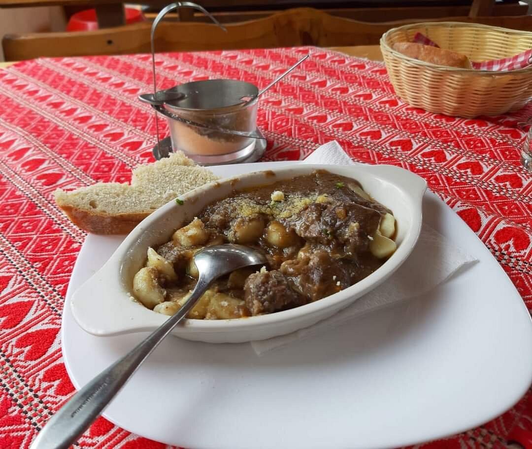 Petehovac in Croatia - a bowl of stew and bread on a table.
