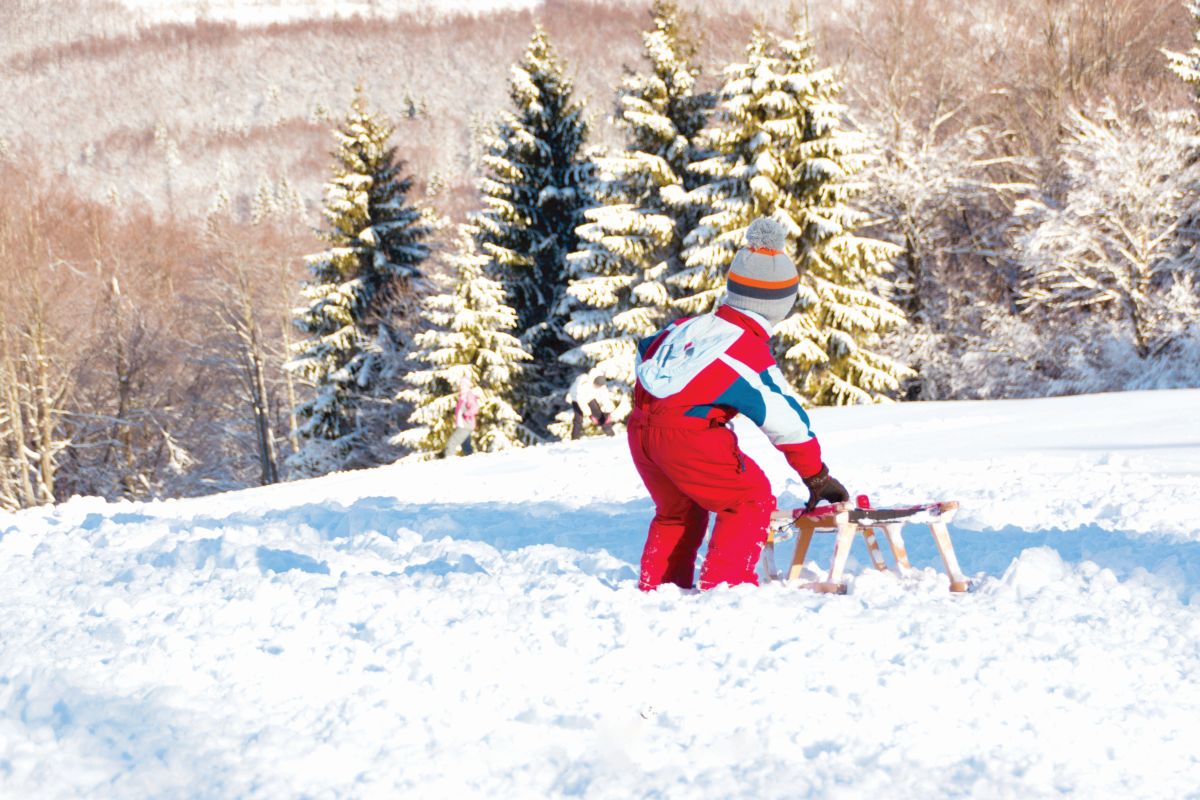 Petehovac in Croatia - a child playing in the snow with a sler.