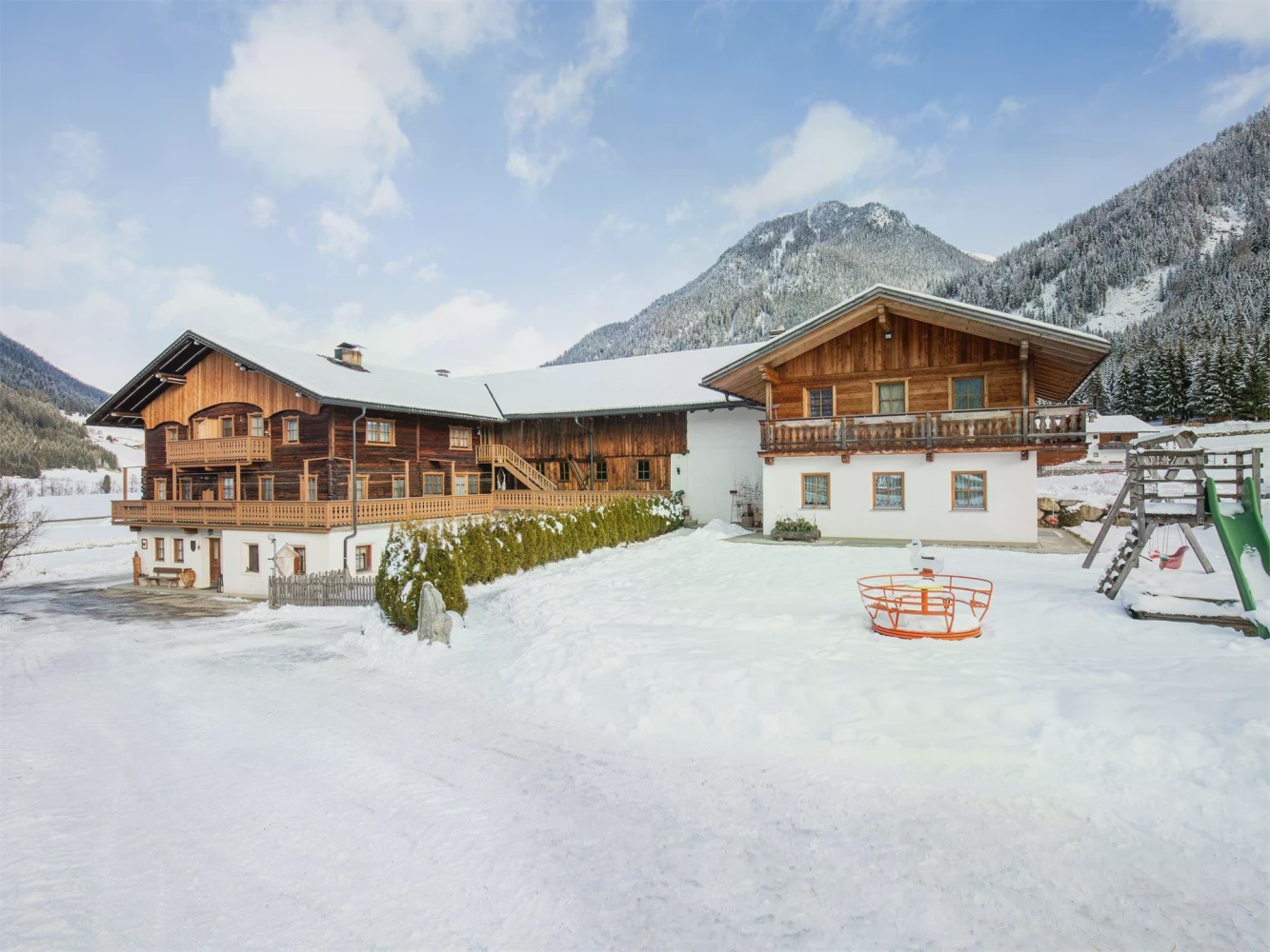 Hundsbach in Germany - a house in the snow with mountains in the background.