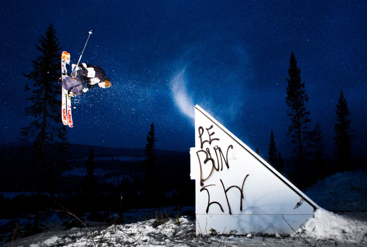 Bräntberget – Umeå in Sweden - a man flying through the air while riding a snowboard.