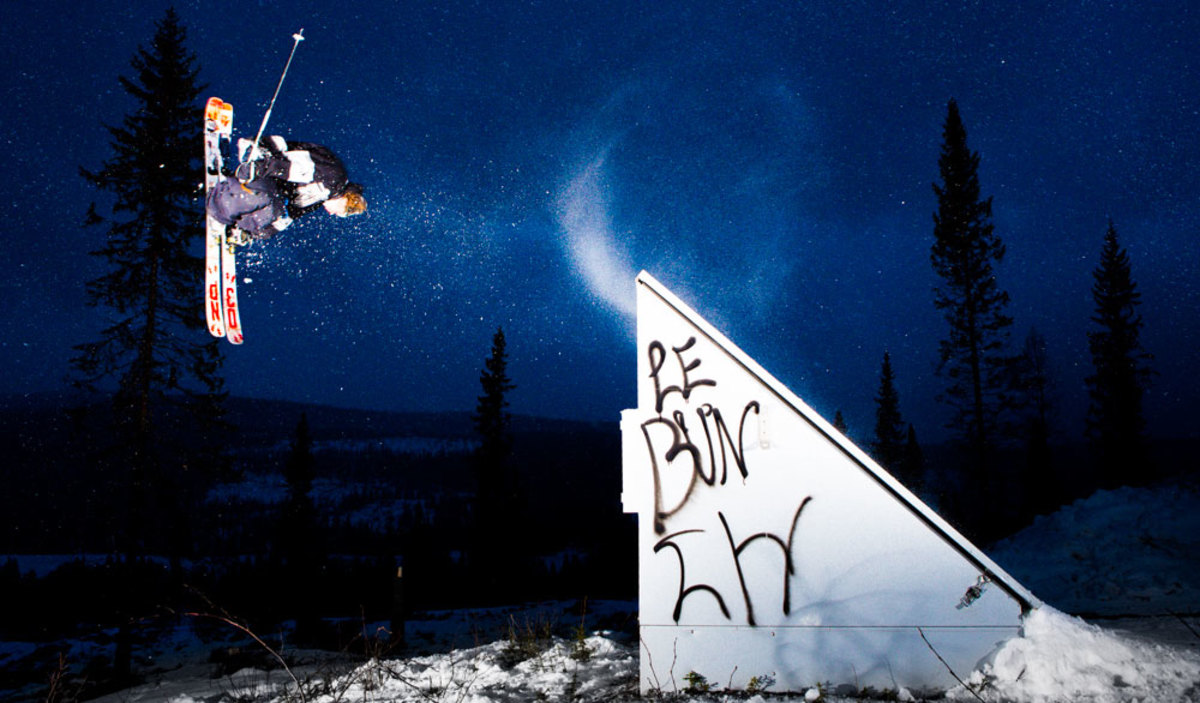 Bräntberget – Umeå in Sweden - a man flying through the air while riding a snowboard.