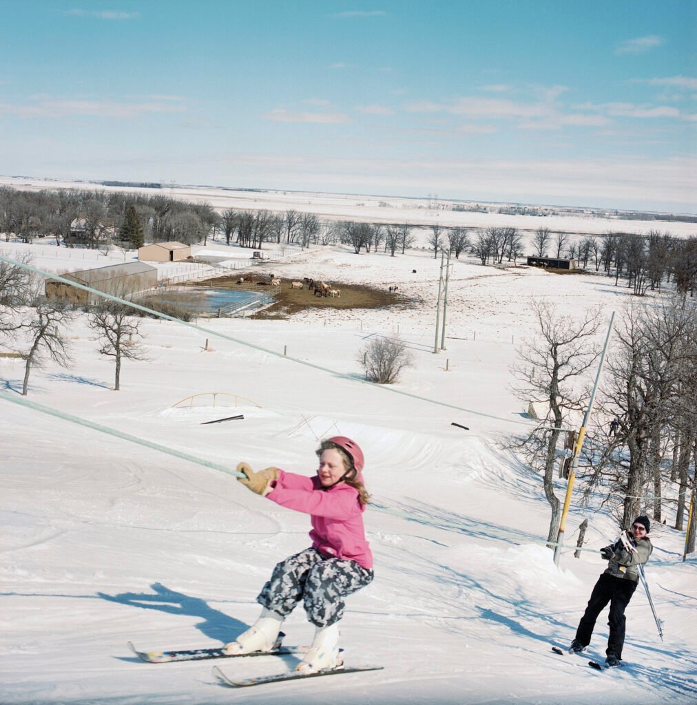 Stony Mountain in Canada - a young girl is skiing down a hill.