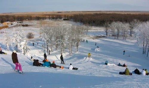 Winter sports scene at Stony Mountain in Manitoba Canada featuring a vibrant winter sports centre amidst stunning snowy landscape.