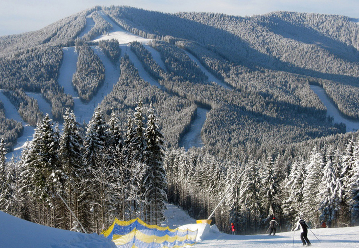 Bukovel in Ukraine - a group of people skiing down a snowy slope.