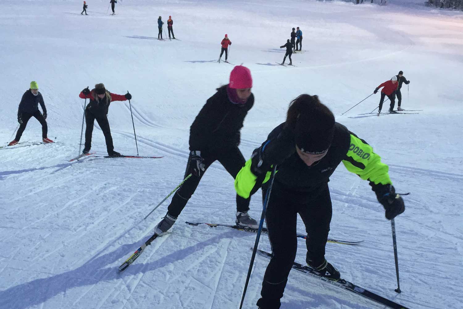 Ormberget – Luleå in Sweden - a group of people skiing down a snowy hill.