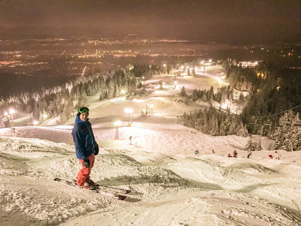 Grouse Mountain in Canada - a man standing on top of a snow covered hill.