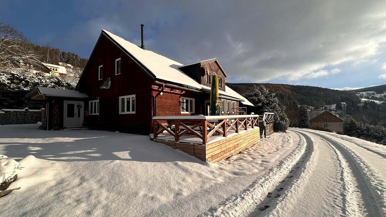 Sagasserovy boudy – Velká Úpa in Czech Republic - a red house with snow on the ground.
