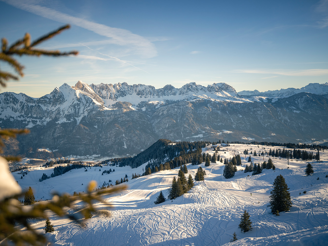 Winter sports enthusiasts enjoy the snow-covered slopes of Flumserberg ski resort in Eastern Switzerland, amidst scenic mountains and traditional Swiss chalets.