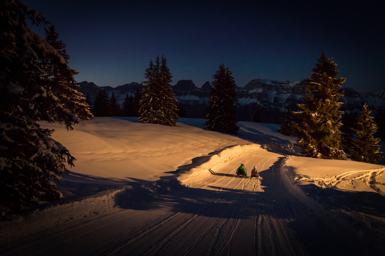 Winter sports scene in Flumserberg Eastern Switzerland with a snowmobile and a chalet amidst a breathtaking winter scenery. A mountain hut adds to the rustic charm of this Swiss haven.