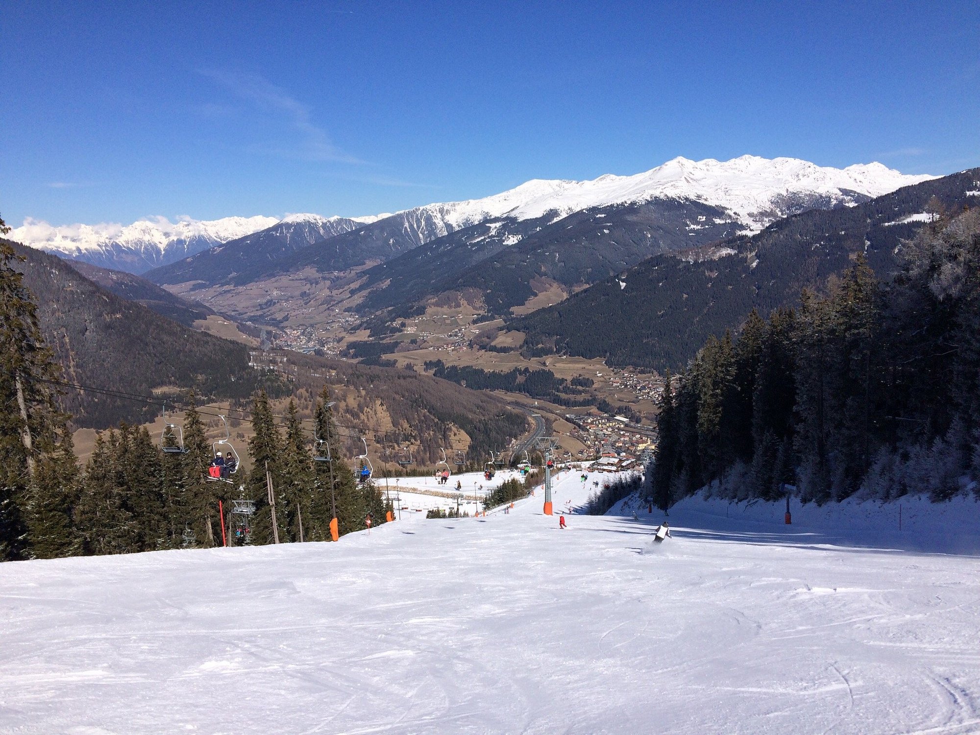Arena Bergeralm in Austria - a person skiing down a snowy slope in the mountains.
