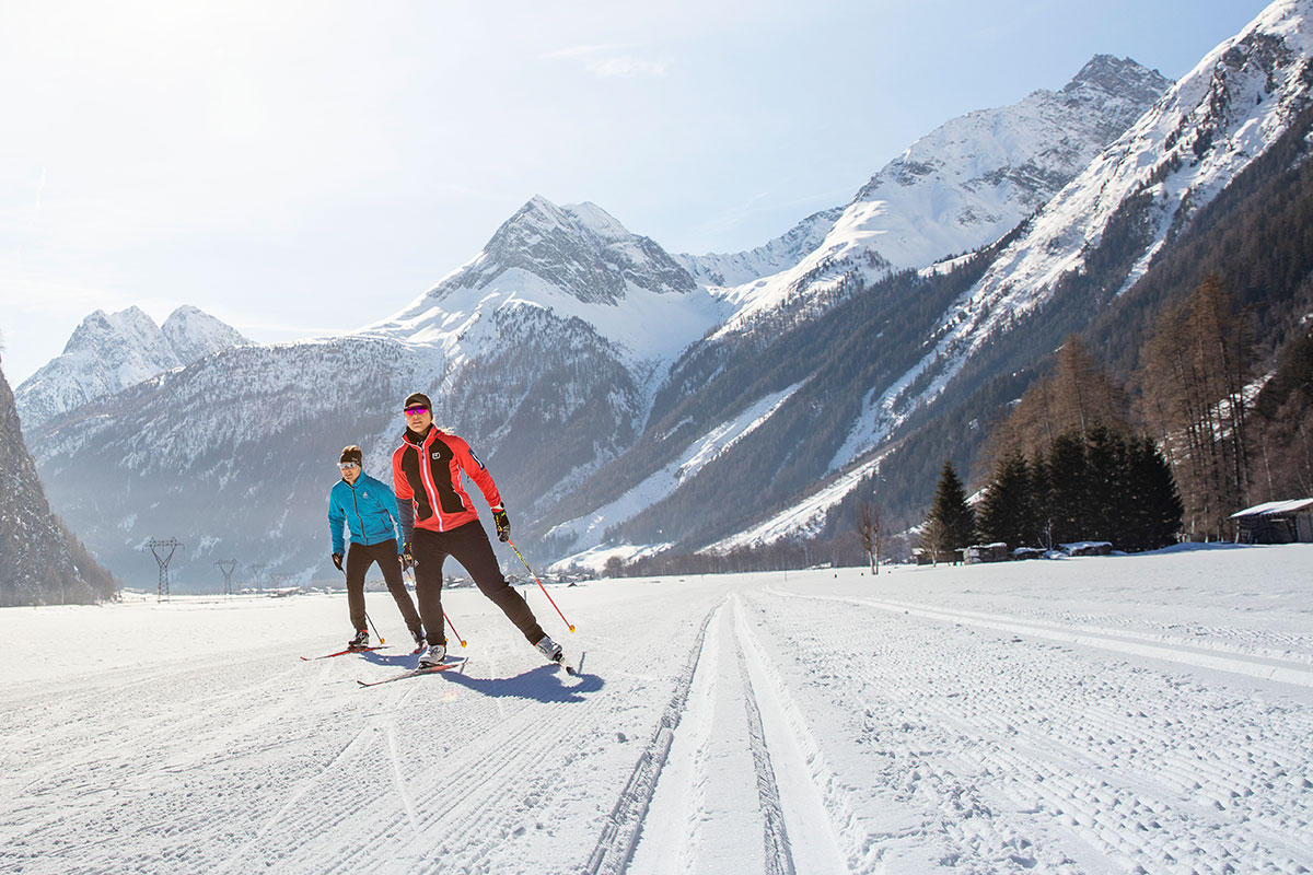 Gries in Austria - two people skiing down a snowy mountain road.