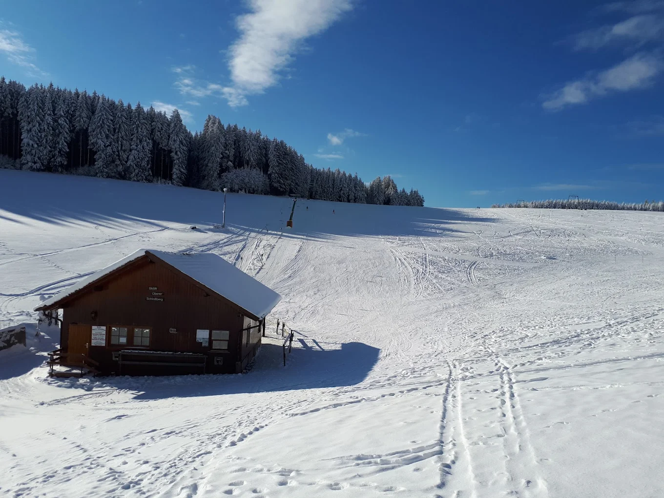 Schlossberg – Oberkirnach in Germany - a small cabin in the middle of a snowy field.