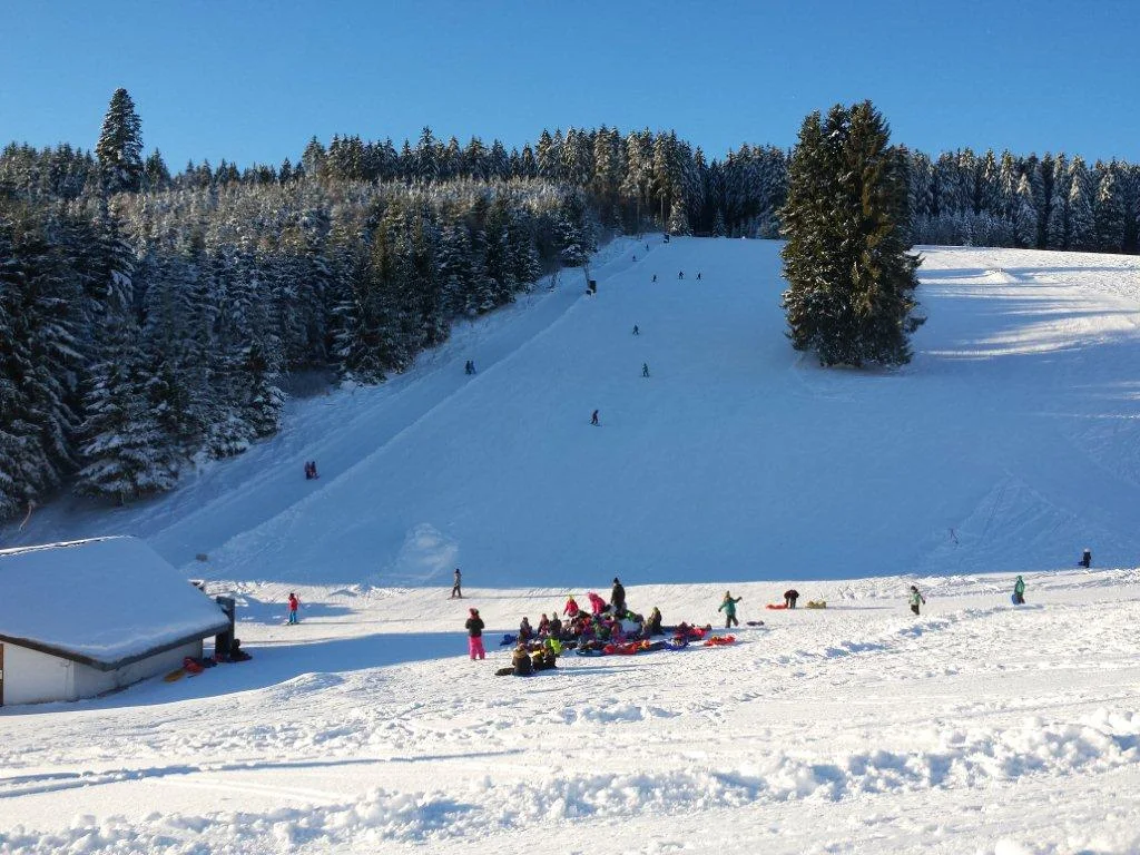 Schlossberg – Oberkirnach in Germany - a group of people riding down a snow covered slope.