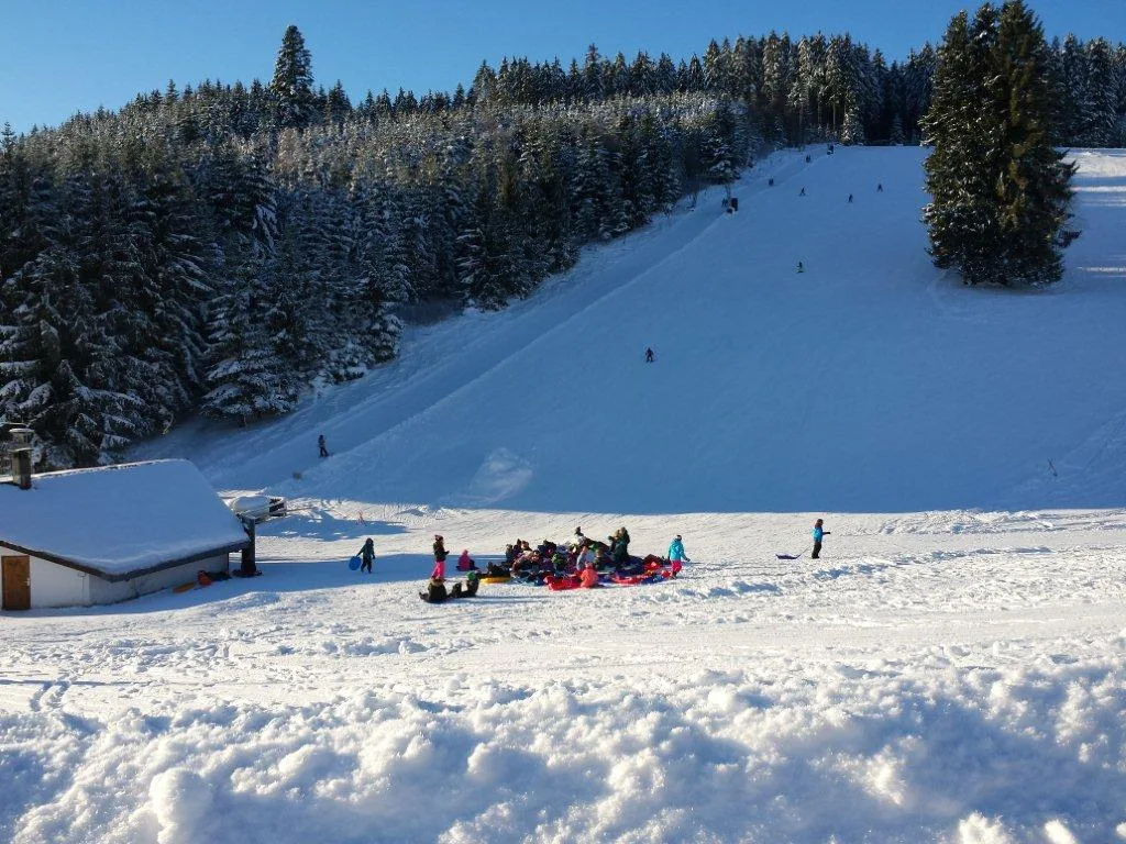 Schlossberg – Oberkirnach in Germany - a group of people standing on top of a snow covered slope.