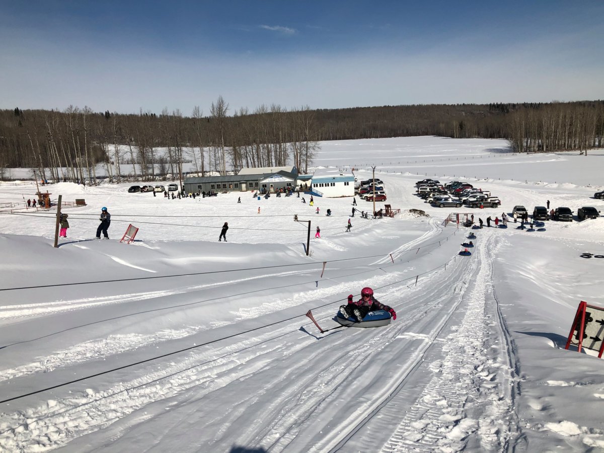 Eastlink Park – Whitecourt in Canada - a group of people riding down a snow covered slope.