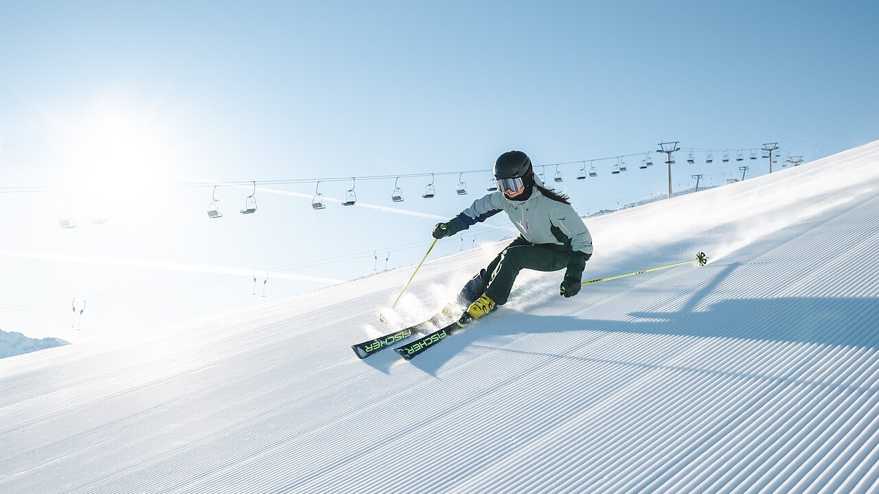 Schlepplift Hochfeldlift in Austria - a person riding skis down a snowy slope.