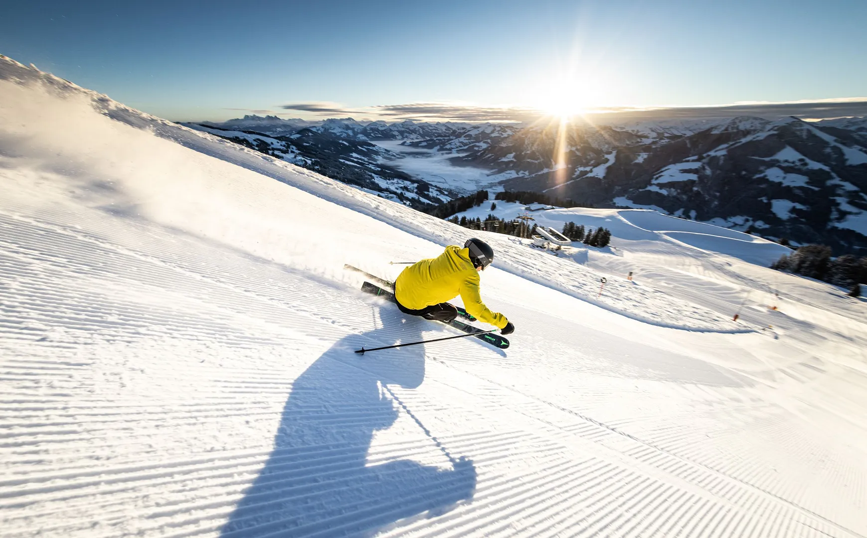 Schlepplift Hochfeldlift in Austria - a person skiing down a snow covered mountain.