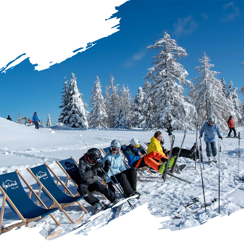 Breathtaking winter scene at Hochrindl-Sirnitz ski resort in Upper Carinthia, Austria, featuring snow-covered slopes bustling with winter sports activities, a ski lift, and a cozy chalet.