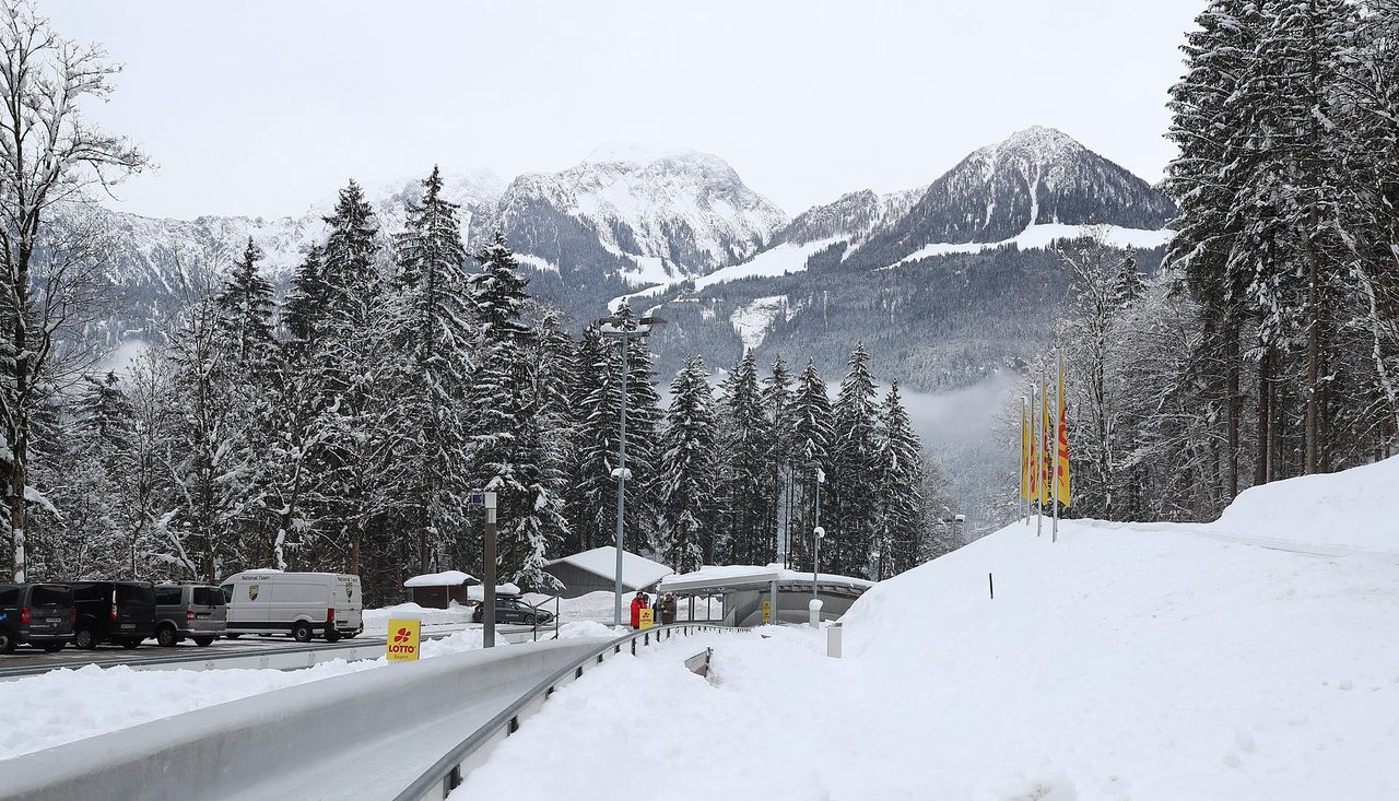 Jenner – Schönau am Königssee in Germany - a snowy road with trees and mountains in the background.
