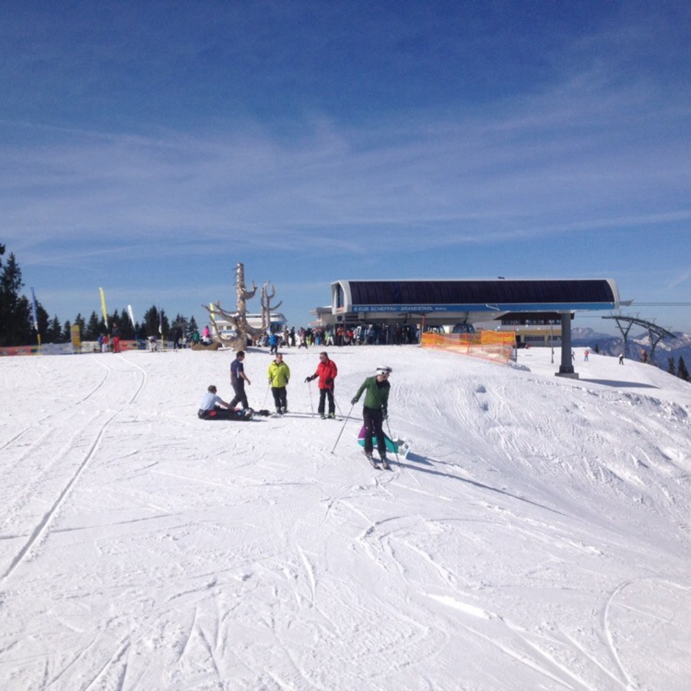 Skilift Gesellschaft in Germany - a group of people skiing down a snow covered slope.