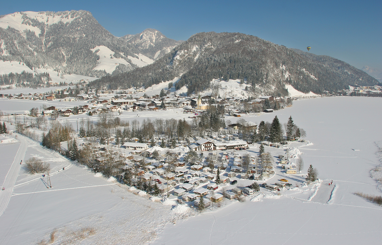 Amberglift – Walchsee in Austria - a small town in the middle of a snowy landscape.