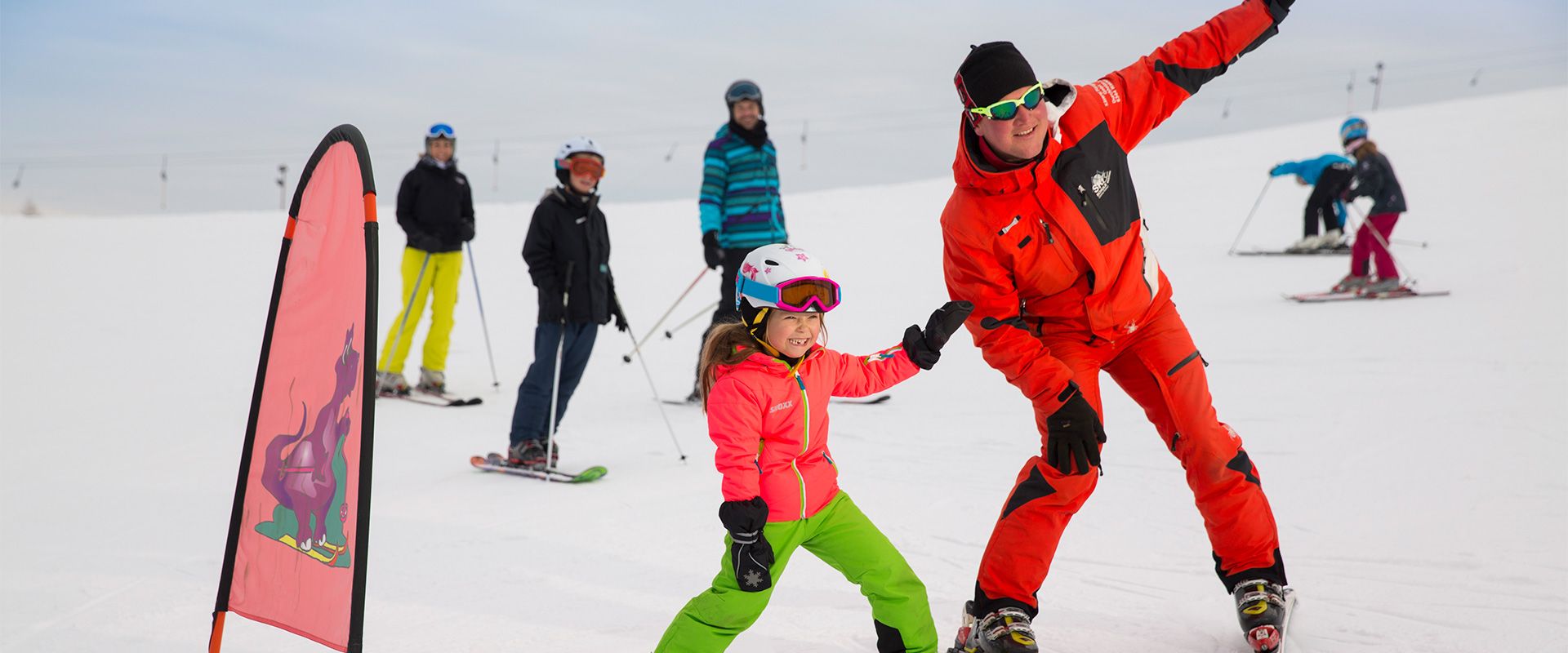 Amberglift – Walchsee in Austria - a group of people standing on a snow covered hill.