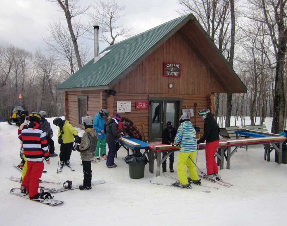 Mont-Blanc QC in Canada - a group of people standing around a table in the snow.