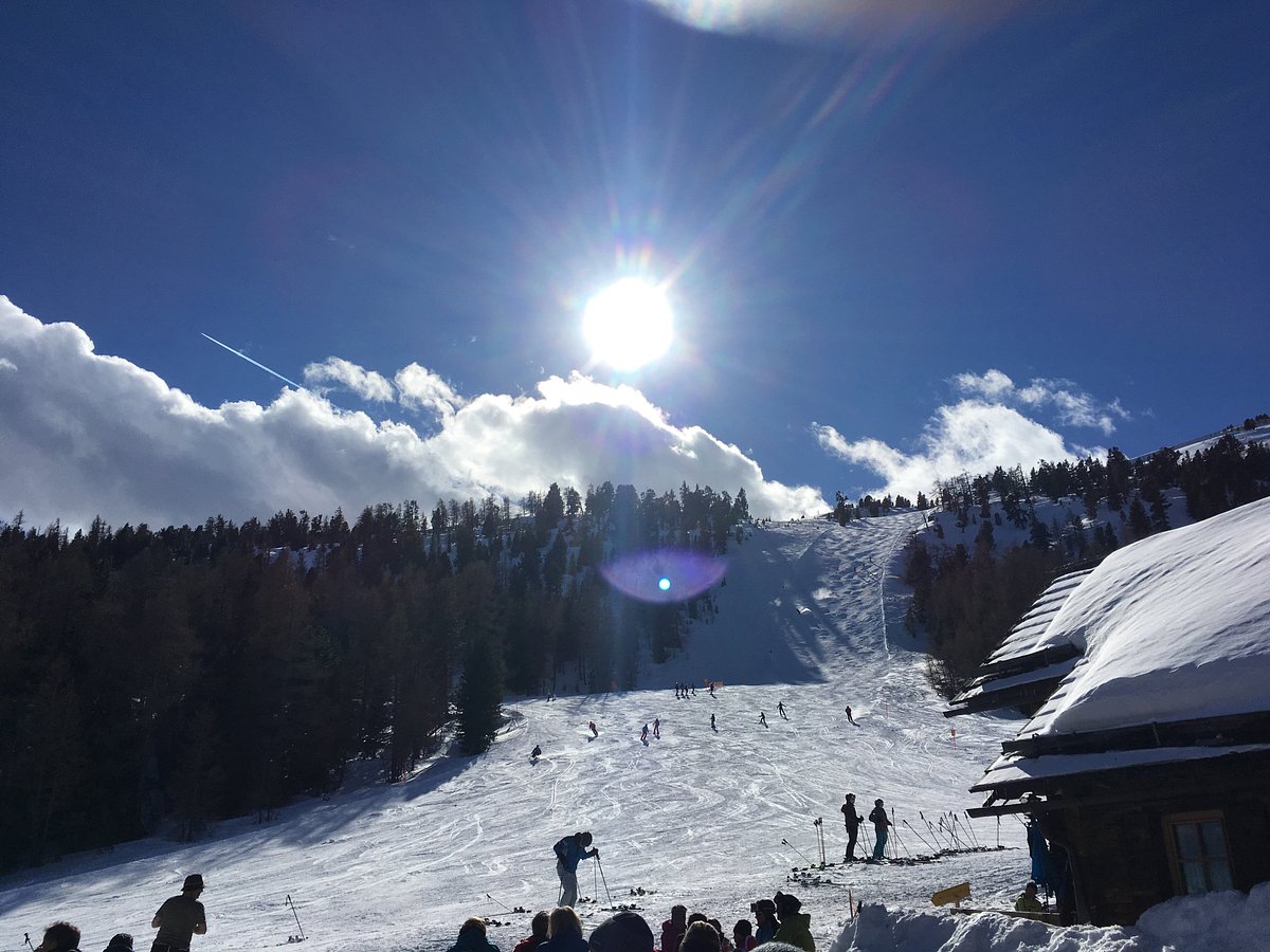 Fanningberg in Austria - a group of people skiing down a snowy slope.