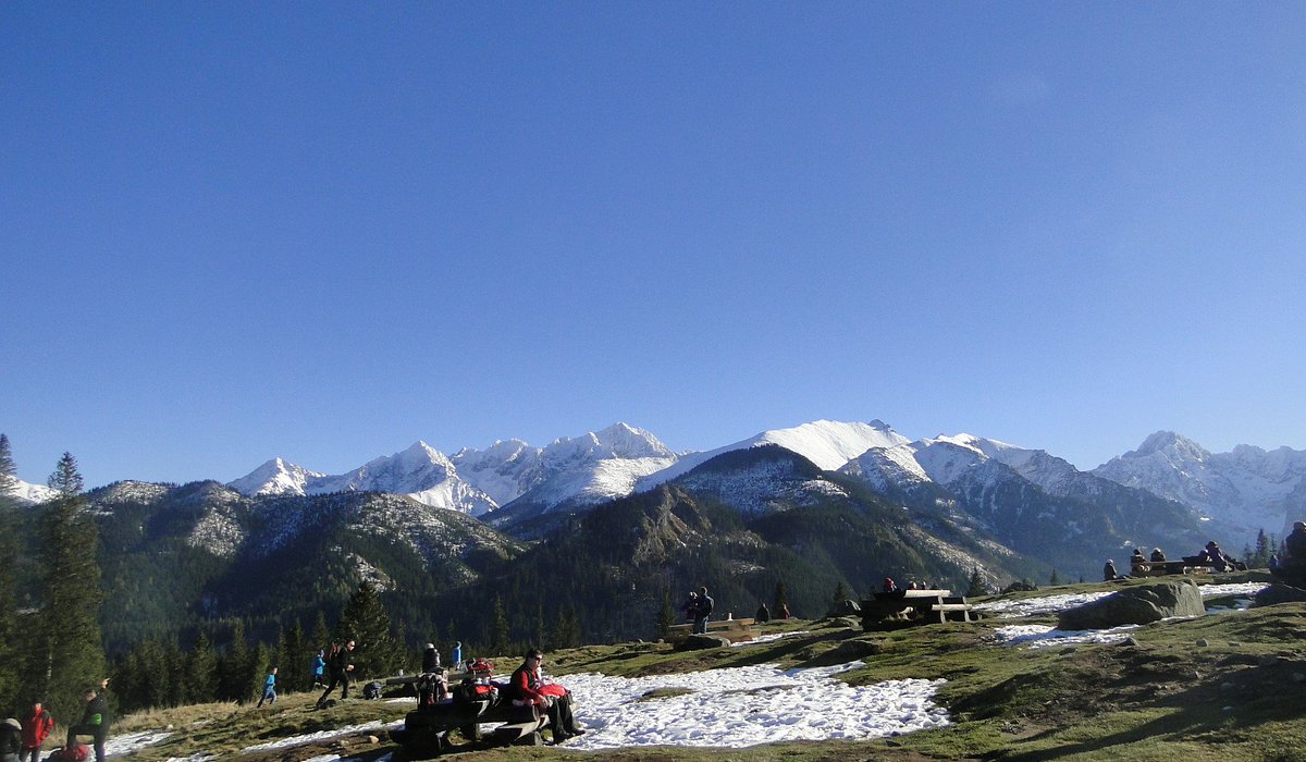 Rusinowa Polana in Poland - a group of people standing on top of a mountain.