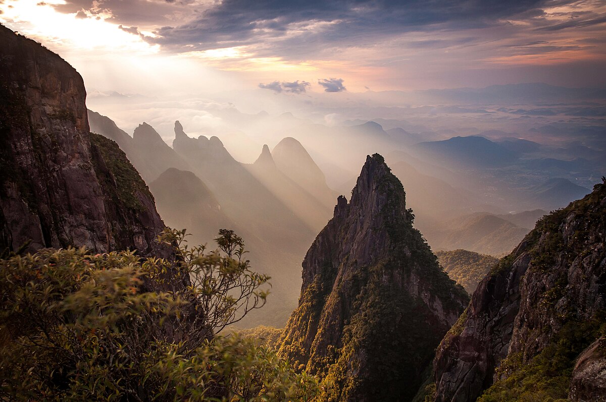 Beiningen in Germany - the sun shines through the clouds over huangshan mountains in china.