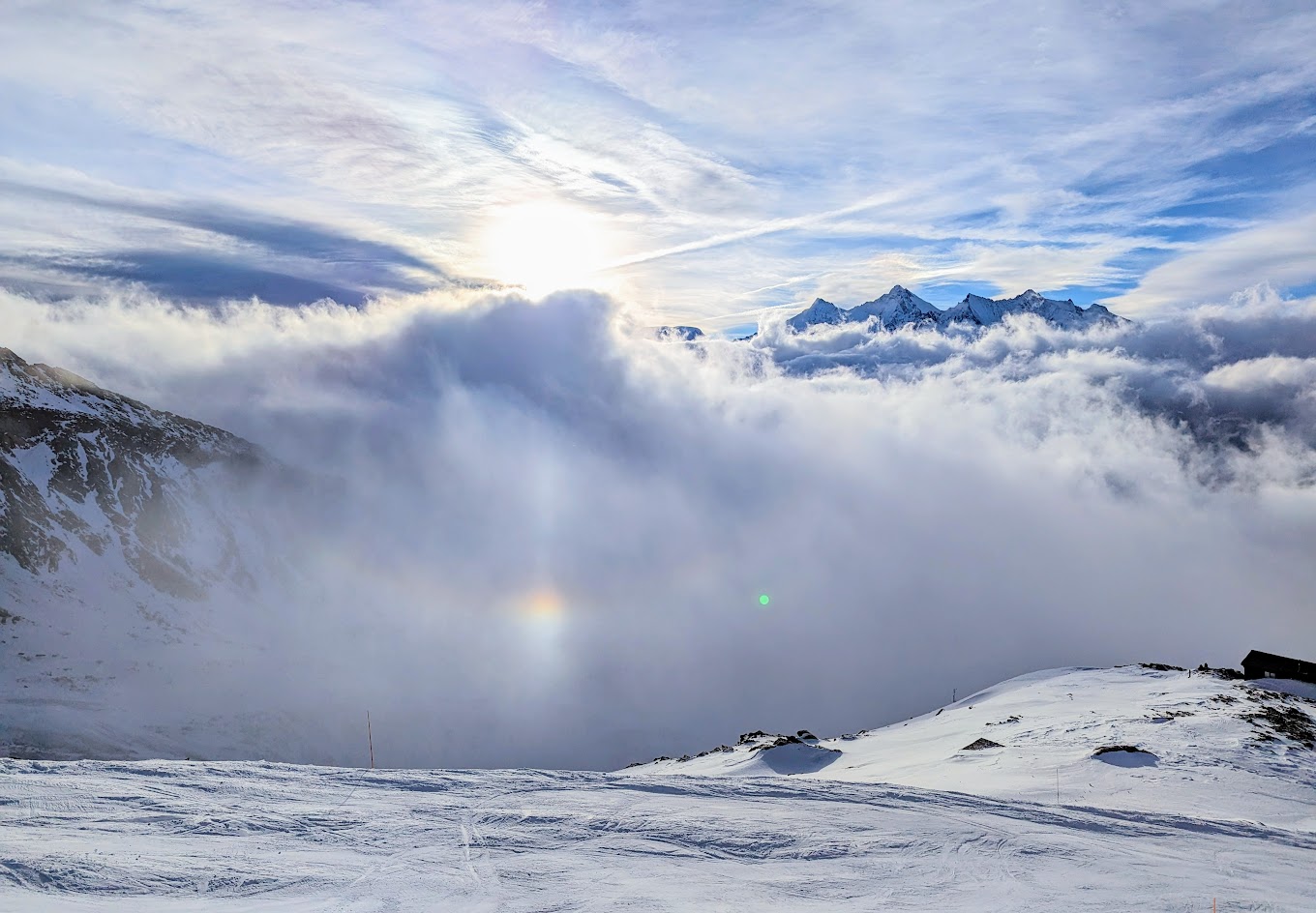 Saas | Grund | Hohsaas in Switzerland - a rainbow in the sky over a snowy mountain.