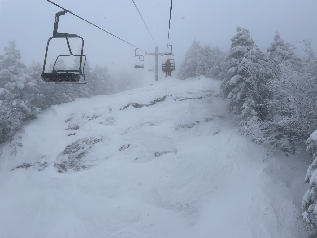 Smugglers' Notch Resort in USA - a ski lift going up a snowy mountain.