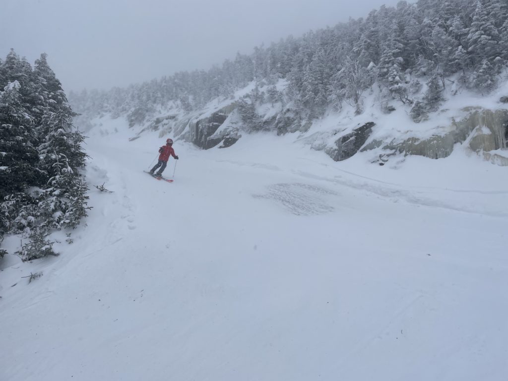 Smugglers' Notch Resort in USA - a person skiing down a mountain covered in snow.