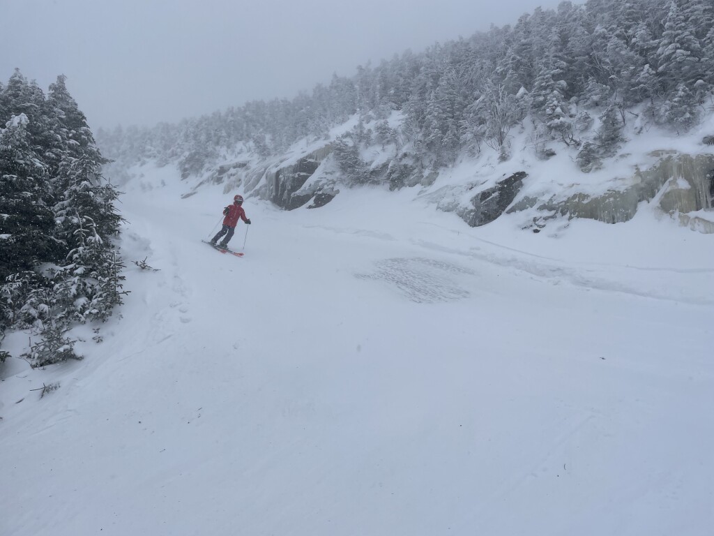 Smugglers' Notch Resort in USA - a person skiing down a mountain covered in snow.