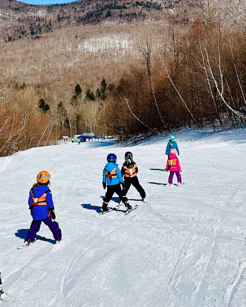 Smugglers' Notch Resort in USA - a group of people skiing down a mountain.
