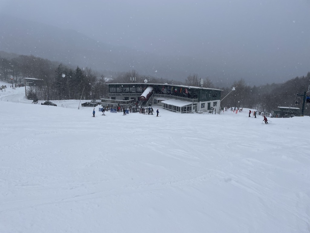 Smugglers' Notch Resort in USA - a group of people skiing down a snowy slope.
