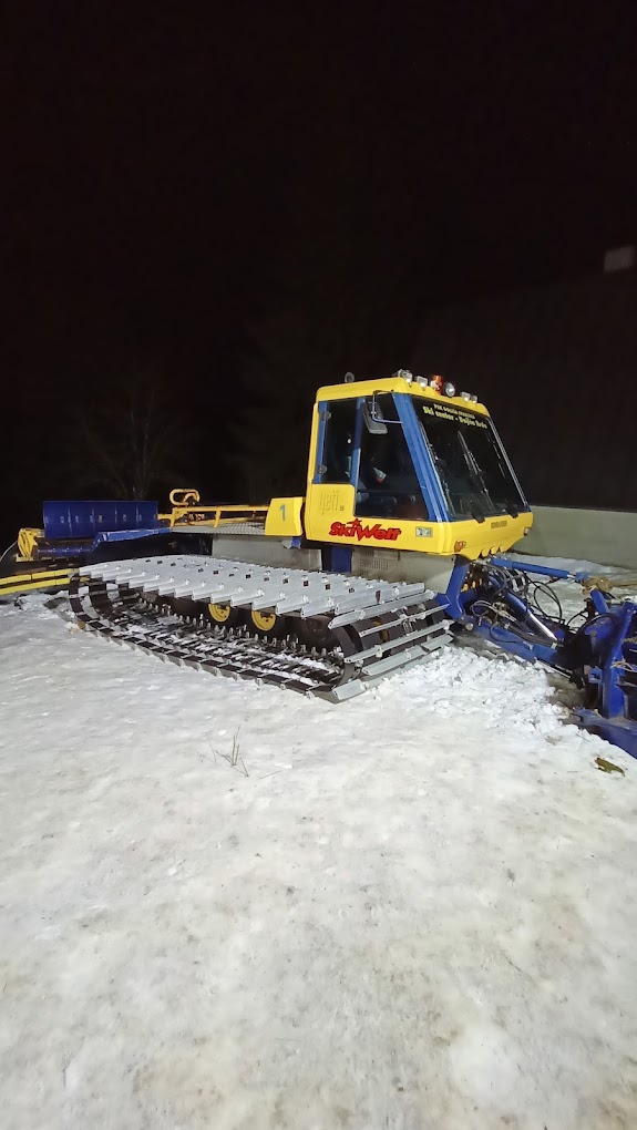 Ski slope Dajićima in Serbia - a snow pler in the snow at night.
