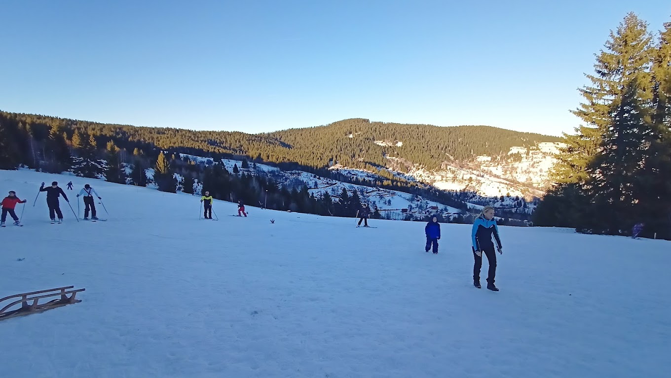 Ski slope Dajićima in Serbia - a group of people skiing down a snowy slope.