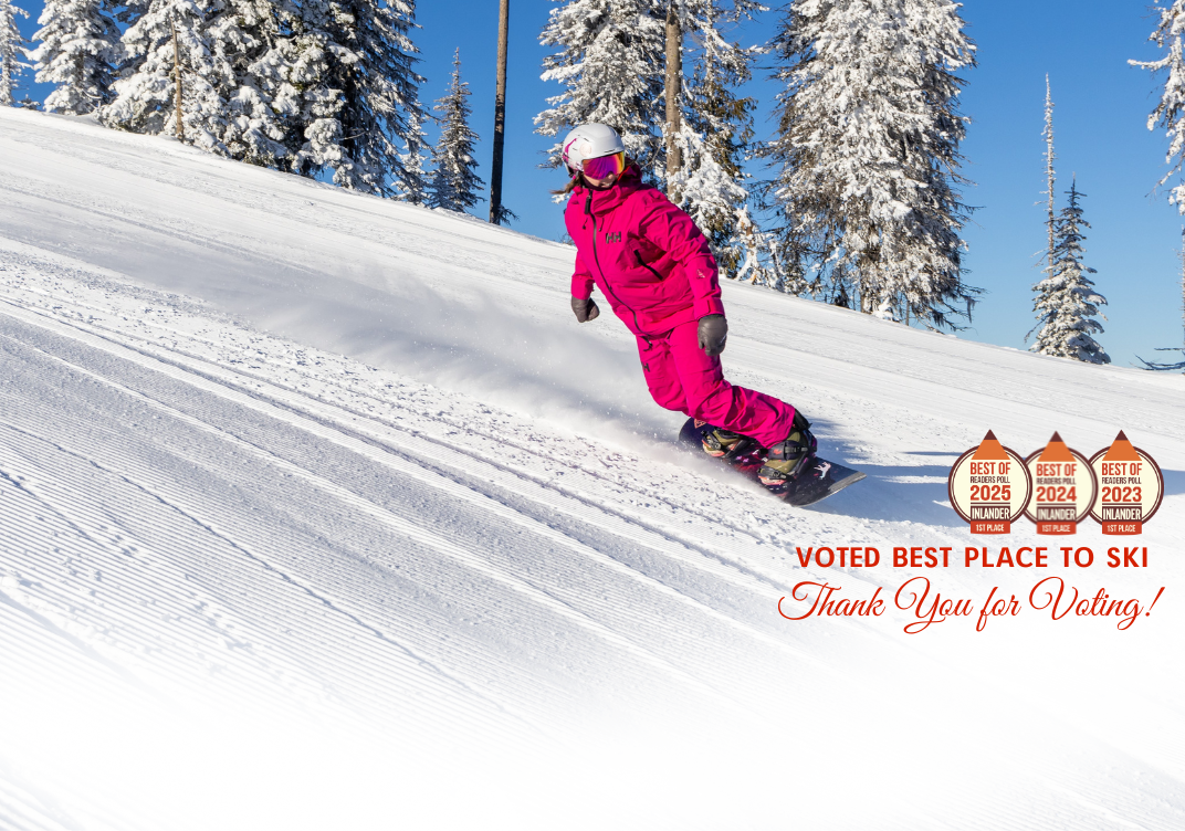 49° North Mountain Resort in USA - a person riding a snowboard down a snowy slope.