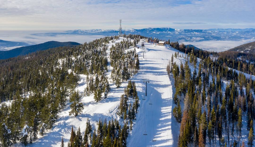 49° North Mountain Resort in USA - a ski slope with trees and snow on it.