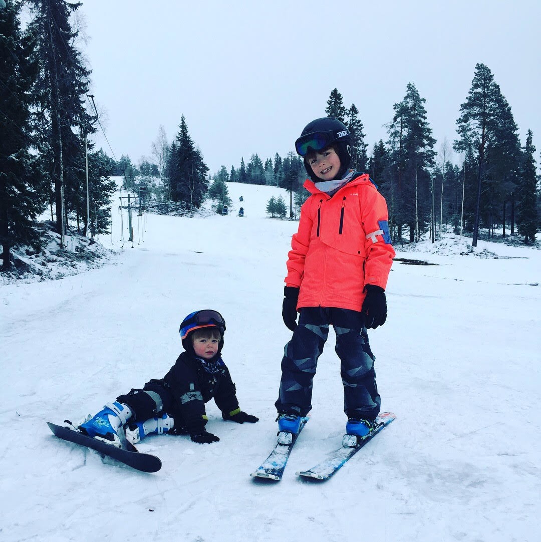 Klackbergsbacken in Sweden - a boy and a boy on skis in the snow.