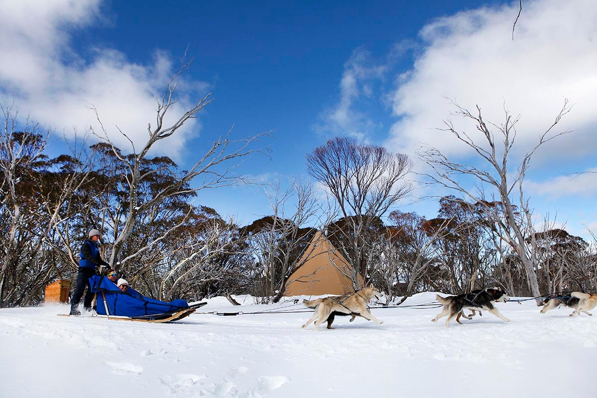 Winter scenery at Dinner Plain, Victoria, Australia, featuring a captivating snow-covered landscape and a lodge, suggesting winter sports activities.
