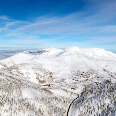 Powder Mountain in USA - a view from the top of a snowy mountain.